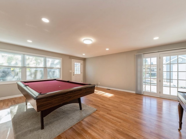 recreation room with billiards, a wealth of natural light, and light hardwood / wood-style flooring