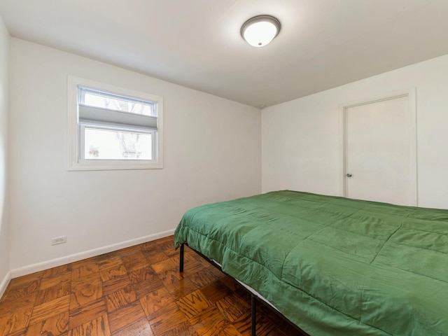 bedroom with dark parquet floors