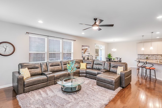 living room with sink, ceiling fan, and hardwood / wood-style floors