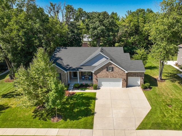 view of front of home featuring covered porch and a front yard