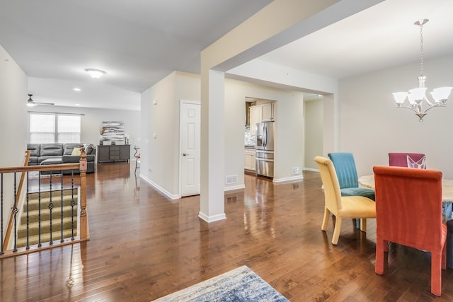 dining room featuring dark hardwood / wood-style flooring and ceiling fan with notable chandelier