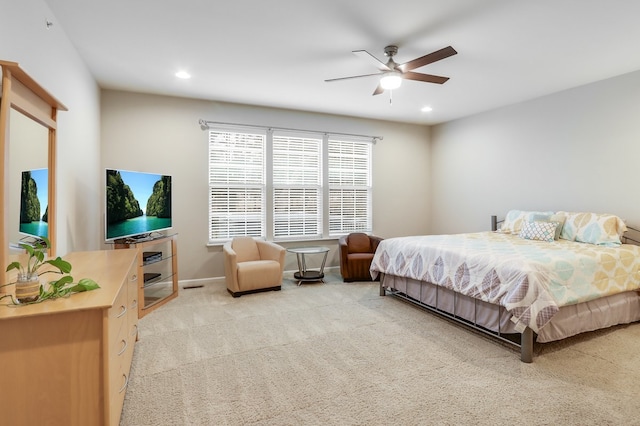 bedroom with ceiling fan and light carpet