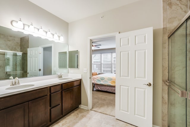 bathroom with a shower with door, ceiling fan, and vanity