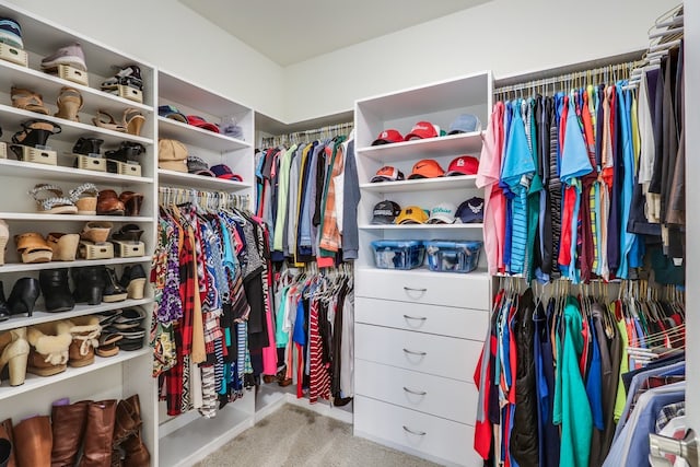 spacious closet featuring light colored carpet