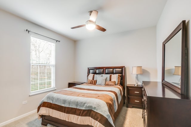 bedroom with ceiling fan and light colored carpet