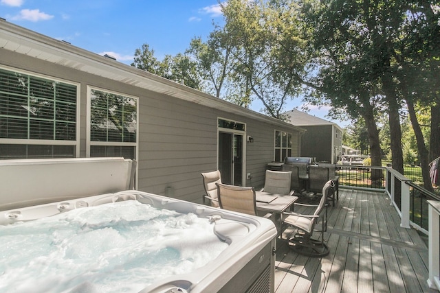 wooden terrace featuring a hot tub