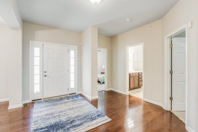 foyer featuring a healthy amount of sunlight and dark hardwood / wood-style floors