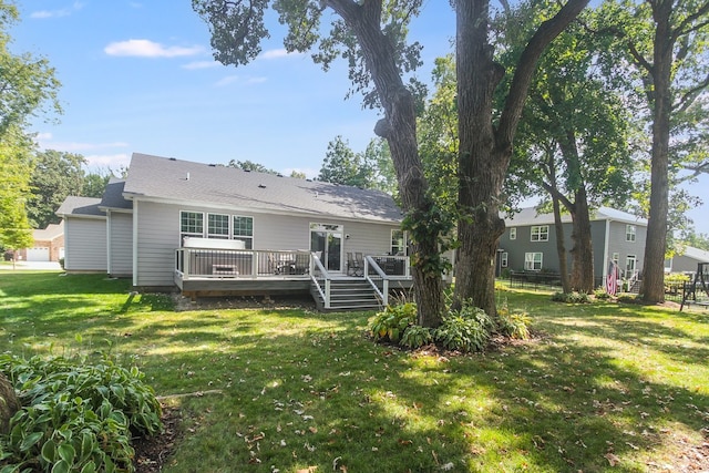 back of house with a deck and a yard