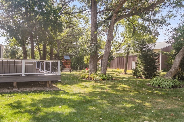 view of yard featuring a playground and a wooden deck