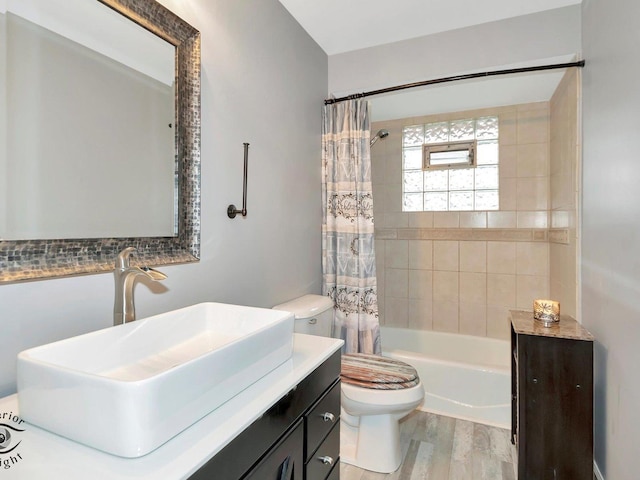 full bathroom with wood-type flooring, shower / bath combo, toilet, and vanity