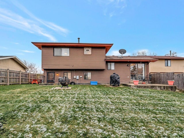 back of house with a yard and a patio