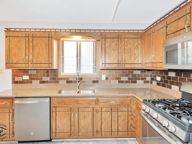 kitchen featuring decorative backsplash, sink, and appliances with stainless steel finishes