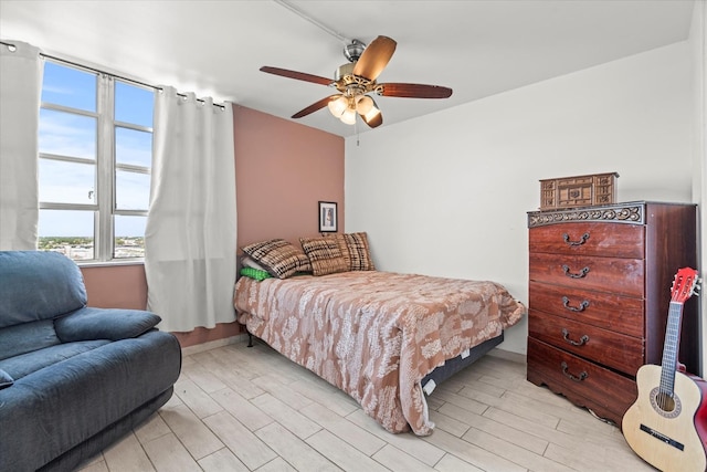 bedroom featuring ceiling fan and light hardwood / wood-style flooring