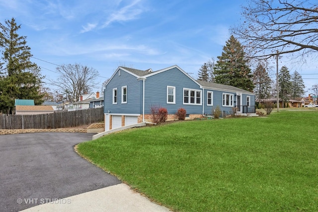 view of front of property featuring a front yard and a garage