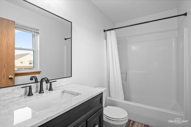 full bathroom with hardwood / wood-style floors, vanity, toilet, and shower / tub combo