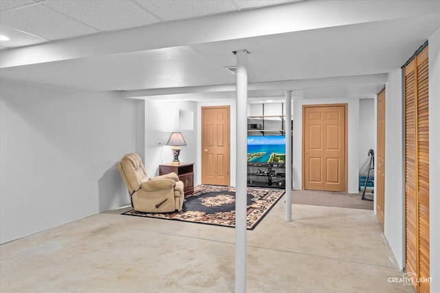 basement with a paneled ceiling