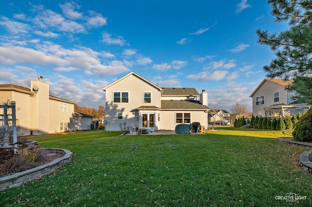 back of property with a lawn