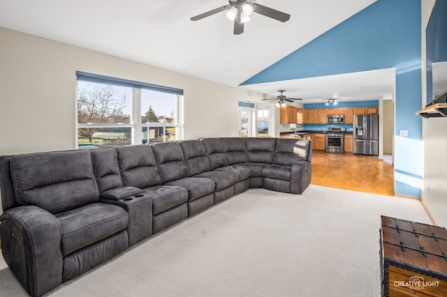 living room with ceiling fan, high vaulted ceiling, and light hardwood / wood-style flooring