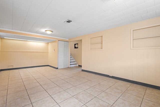 laundry room with washer and dryer, gas water heater, and light tile patterned floors