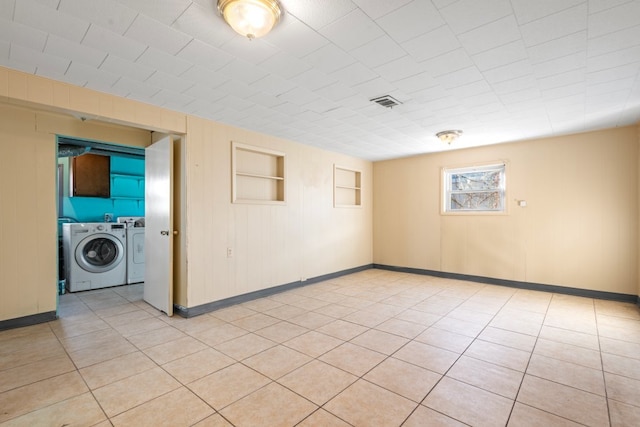 spare room with light tile patterned floors and built in shelves