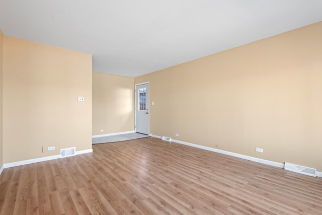 spare room featuring light hardwood / wood-style floors