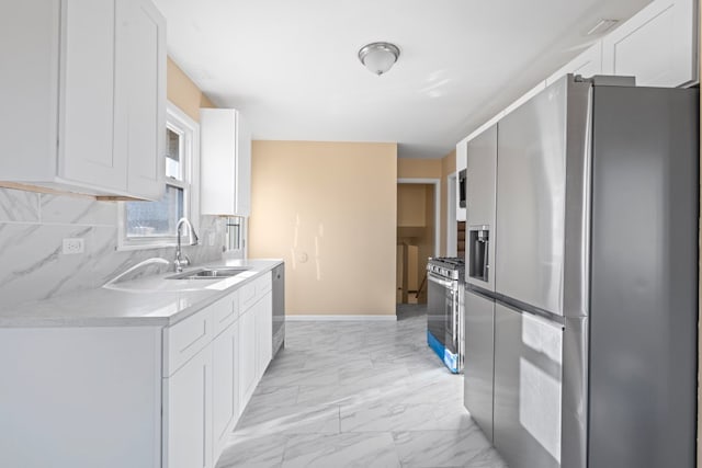 kitchen with decorative backsplash, sink, white cabinetry, and stainless steel appliances