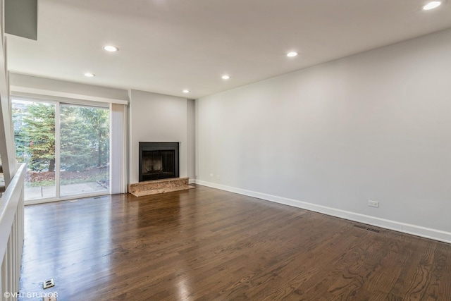 unfurnished living room with dark wood-type flooring