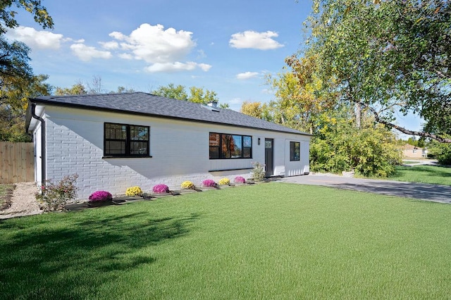 back of house featuring a yard