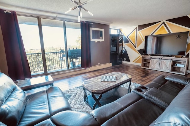 living room featuring a textured ceiling, hardwood / wood-style flooring, and a wealth of natural light