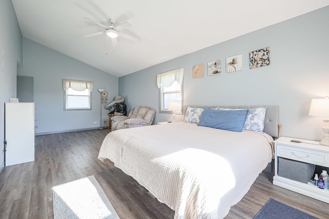 bedroom with dark hardwood / wood-style floors, vaulted ceiling, multiple windows, and ceiling fan