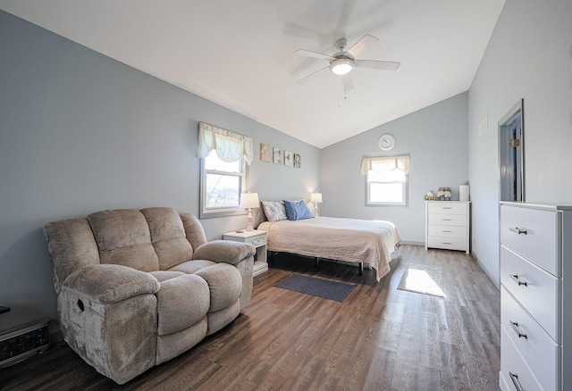 bedroom featuring hardwood / wood-style floors, multiple windows, lofted ceiling, and ceiling fan