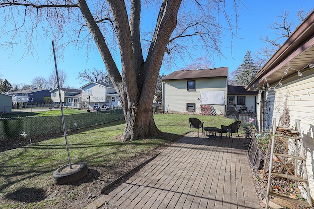 wooden terrace with a yard and a patio