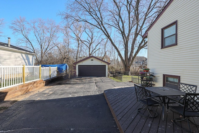 wooden terrace with an outbuilding and a garage