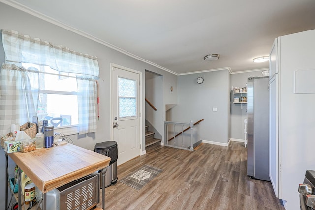 home office with hardwood / wood-style floors and ornamental molding