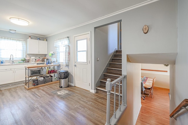 interior space featuring light hardwood / wood-style floors, white cabinetry, and a wealth of natural light