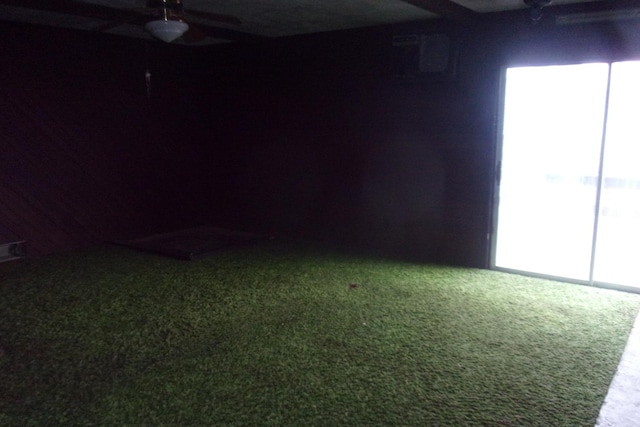 empty room featuring ceiling fan and carpet floors