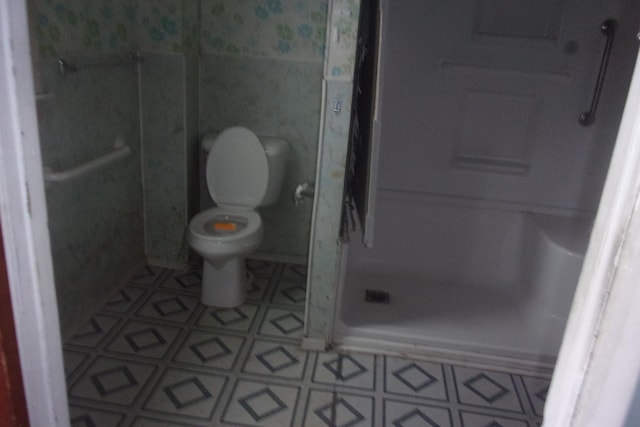 bathroom with toilet and walk in shower