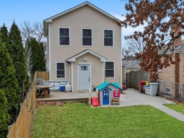 back of house featuring a deck and a yard