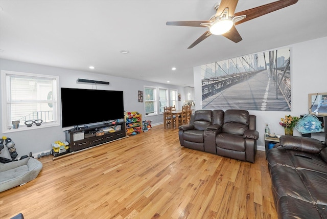 living room with ceiling fan and hardwood / wood-style floors