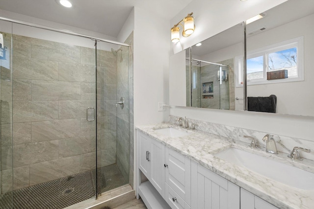 bathroom featuring vanity and an enclosed shower