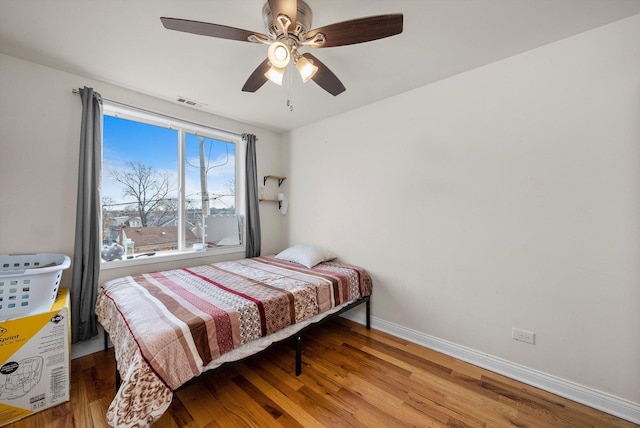 bedroom featuring hardwood / wood-style flooring and ceiling fan