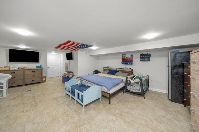 bedroom with stainless steel refrigerator