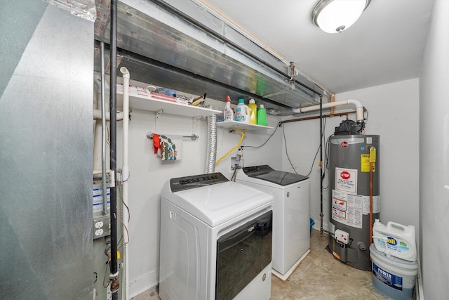 clothes washing area with gas water heater and independent washer and dryer