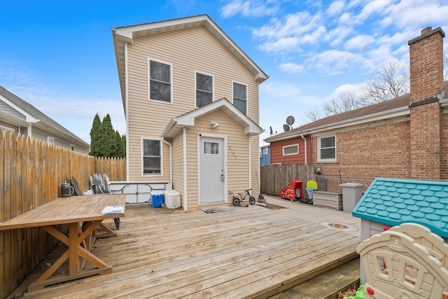 rear view of property featuring a deck