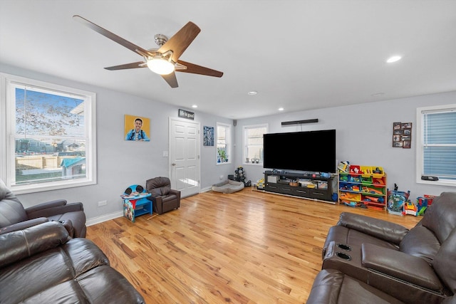 living room featuring hardwood / wood-style flooring and ceiling fan