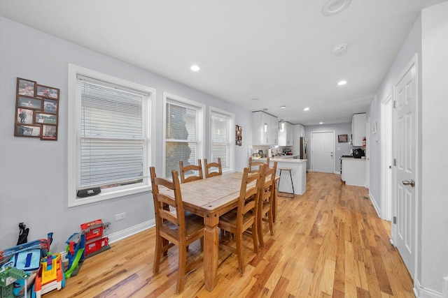 dining space with light hardwood / wood-style flooring