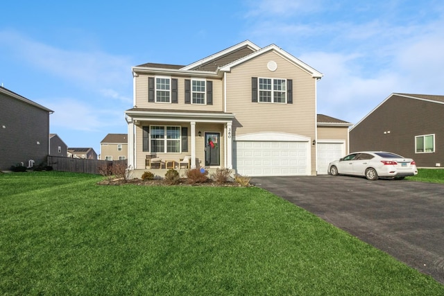 view of property featuring a porch, a garage, and a front yard