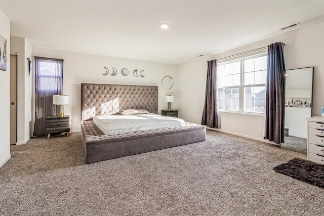 carpeted bedroom featuring multiple windows