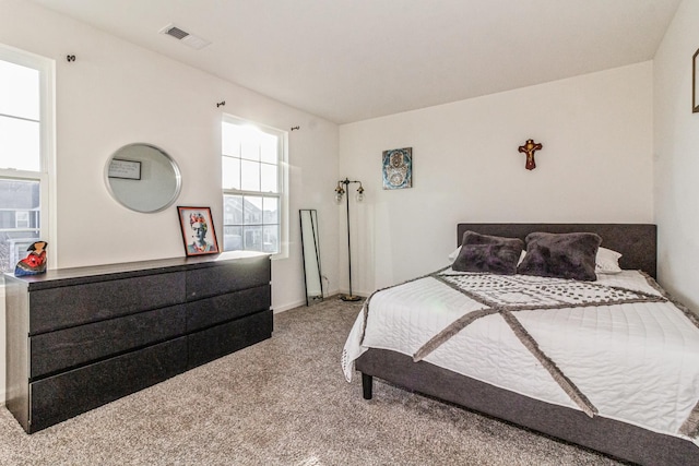 bedroom with light colored carpet