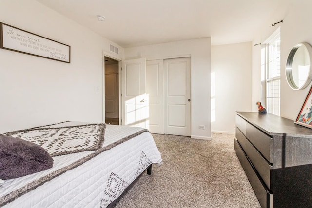 carpeted bedroom with a closet